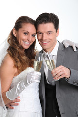Bride and groom drinking champagne