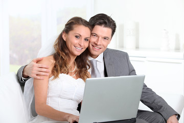 Bride and groom surfing on internet