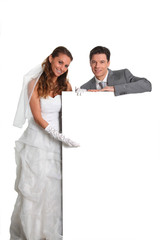 Bride and groom holding whiteboard