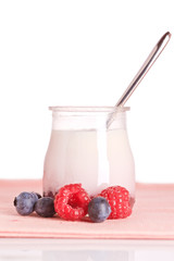 Yogurt and fresh raspberries and blueberries