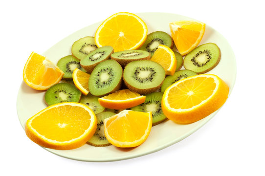 slices of kiwi and orange on the plate isolated on white