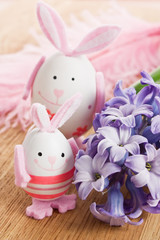 Obraz na płótnie Canvas Easter rabbit egg decoration with flower and feather