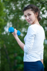 woman doing  exercise with dumbbell
