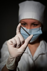 young pretty surgeon holding nail for osteosynthesis