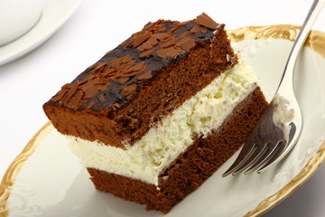 A slice of chocolate cake with white cream inside