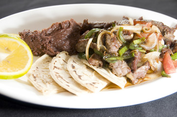beef stir fry with mashed beans and tamales Nicaragua