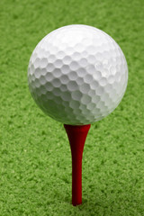 Golf ball on red tee