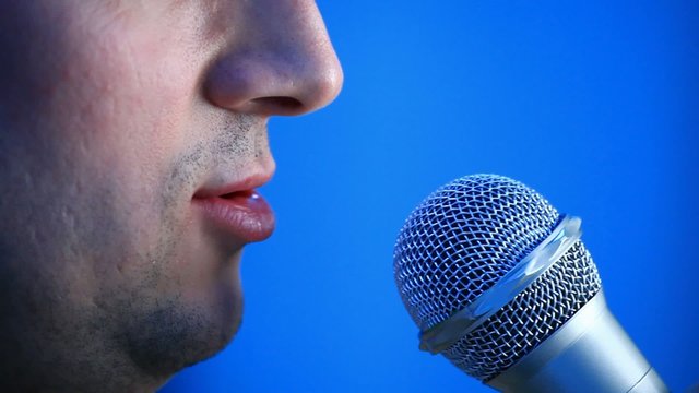 Side view of talking man with microphone