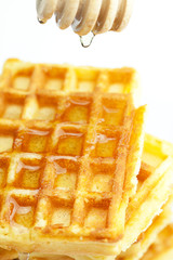 delicious Belgian waffles and stick to honey isolated on white