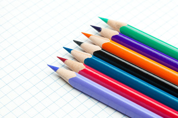 plaid notebook with a spiral  and colored  pencil