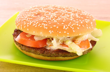 hamburger with vegetables on the table