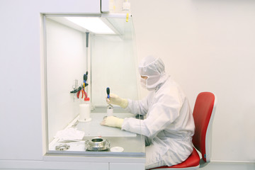 technician working in a clean room in laboratory