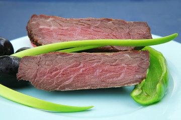 meat food : roasted fillet mignon on blue plate with chives