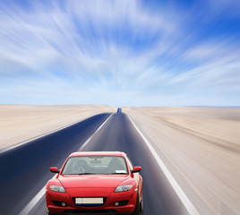 Obraz na płótnie Canvas Red car on desert road