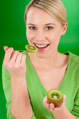 Healthy lifestyle - happy woman holding kiwi and teaspoon