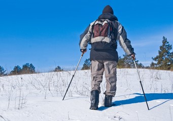 Fototapeta na wymiar man climbing on a snowbound hill
