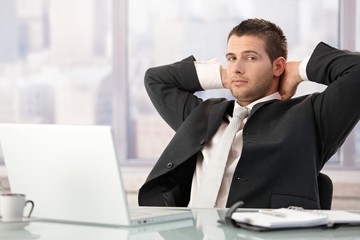 Young businessman relaxing in office