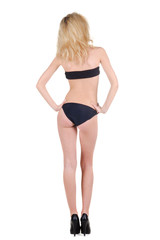 Fototapeta premium Beautiful young woman looking at wall. Rear view.