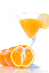 Wine glass with orange juice and fruit