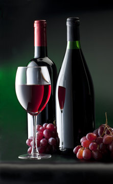 still life with red wine on green background