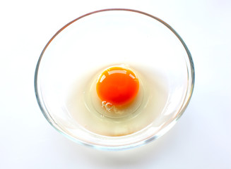 Broken chicken egg in the bowl as food ingredient