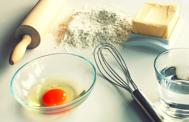 Egg, butter and flour ingredients ready to make dough