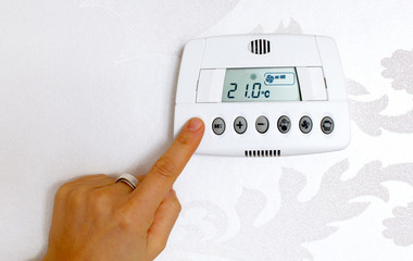 Thermostat temperature digital setting in a modern home