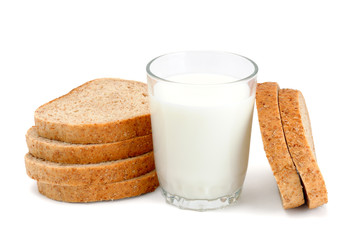 Glass of milk and sliced bread on white background