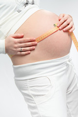 pregnant woman with measuring tape