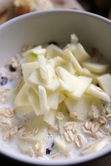 Muesli for breakfast with oatmeal, raisins and fresh apples