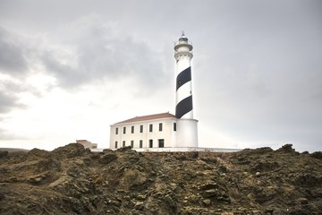Fototapeta na wymiar Favaritx lighthouse on rock cape