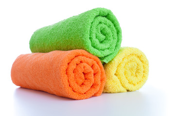 stack of fresh colorful towels rolls isolated