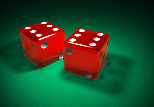 Red transparent dice on green surface