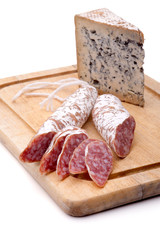 Rustic still life with cutting board, smoked sausage, and mature