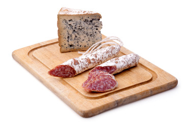 Rustic still life with cutting board, smoked sausage, and mature