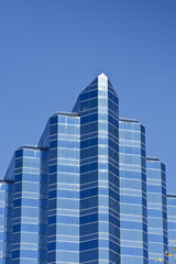 Obraz premium Blue Angled Office Tower on Deep Blue Sky