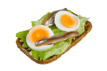 Open sandwich with egg, salad and anchovy