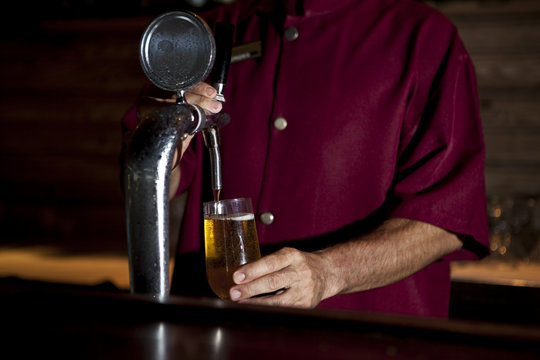 Bartender Pouring Draught Beer On Tap