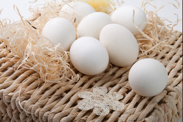 White eggs lying on a straw support