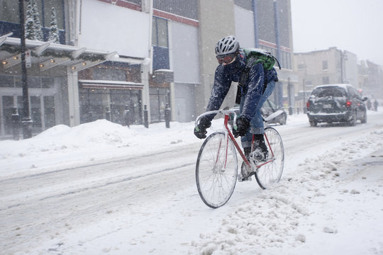 Bicycle courier in winter snow storm