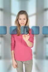 Teenage girl touching virtual screen