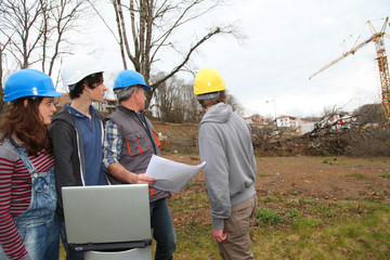 Adult with group of teenagers in professional training