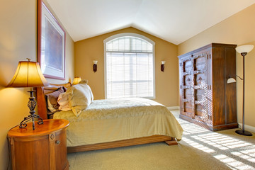 Master bedroom with large bed and old closet