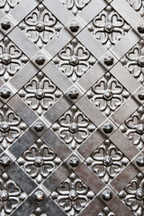 Old door with ornament in stone wall.