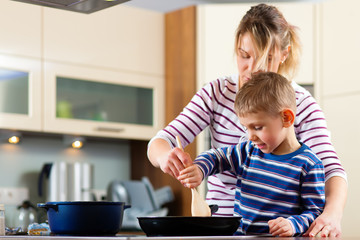 Family cooking in kitchen