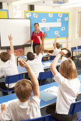 Schoolchildren Studying In Classroom With Teacher