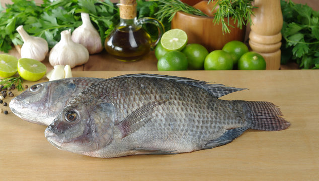 Raw fish called "tilapia" on cutting board
