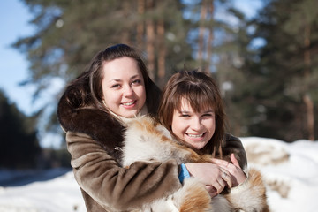 two smiling girls in winter
