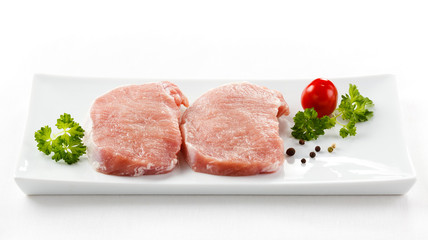 Fresh raw pork on white plate