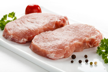 Fresh raw pork on white plate